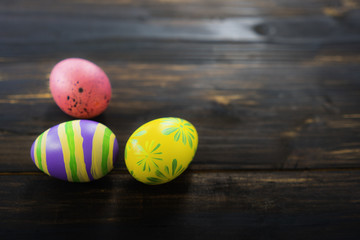 groups of colorful painted easter eggs on the wooden background for cerebration