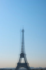 Fototapeta na wymiar Travel concept. Eiffel Tower in Paris, France, tourism in Europe. Top Destinations in Europe. Blurred tower in the camera lens.