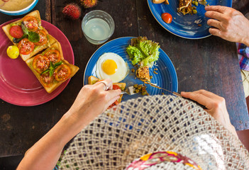 wooden table useful food fruit hands hands of men and women they eat top view.