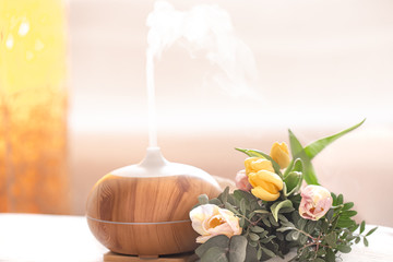 Aroma oil diffuser lamp on the table .