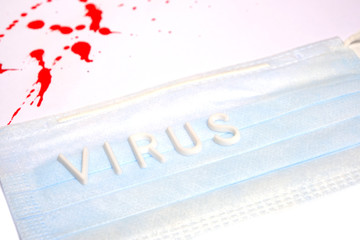 Medical protective mask with the inscription virus on a white background with blood drops.