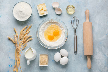 Ingredients for preparing bakery and utensils on color background
