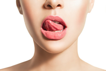 Woman's tongue seductively licking lips. Beautiful chubby lips. seduction concept