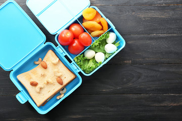 School lunch box with tasty food on table