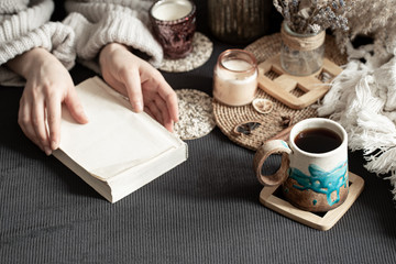 Still life with a beautiful Cup and female hands.