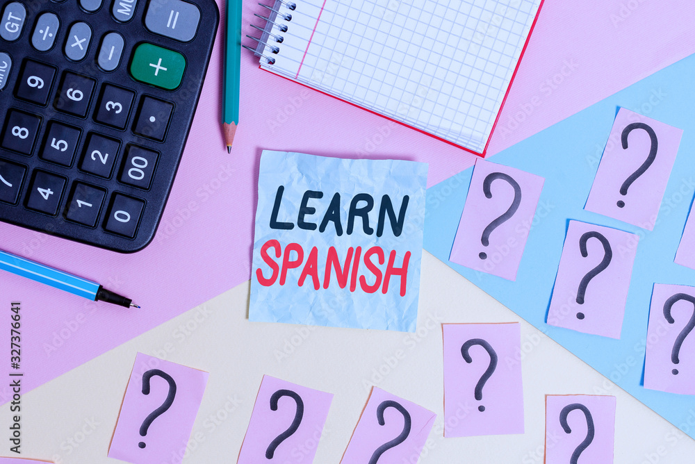 Aufkleber writing note showing learn spanish. business concept for gain or acquire knowledge of speaking and w