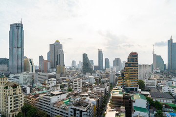 Fototapeta na wymiar Aerial cityscape of picturesque Bangkok at daytime from rooftop. Panoramic skyline of the biggest city in Thailand. The concept of metropolis.