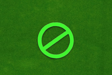Sign prohibiting green on a green background. Warning, restriction.