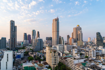 Aerial cityscape of picturesque Bangkok at sunset from rooftop. Panoramic sunrise skyline of the biggest city in Thailand. The concept of metropolis.