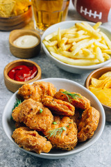Table fof tasty snacks and beer prepared for watching sports on TV. Selective focus