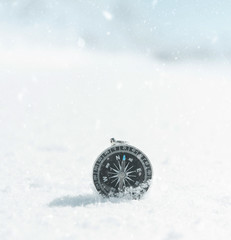 Magnetic compass in snowdrift in winter.