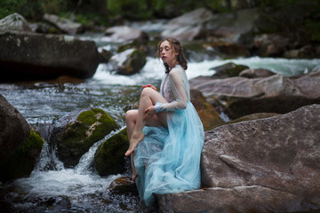 The Tale of the Mermaid. Tale of the River Nymph. Girl in a blue dress by the river.
