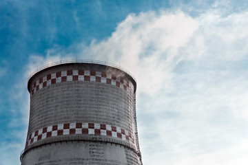Cooling tower, desuperheater, smoke from a pipe of an industrial plant or thermal power plant on a...
