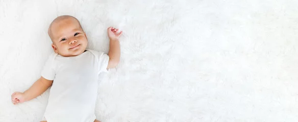 Fototapeten Portrait newborn baby happy over white background, topview © Nattakorn