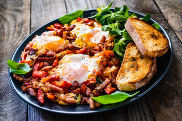 Shakshuka - fried eggs with bacon and vegetables