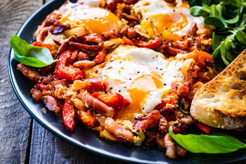 Shakshuka - fried eggs with bacon and vegetables