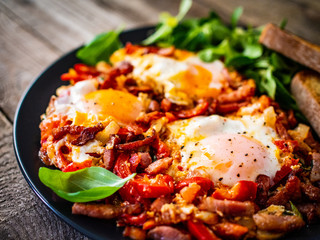 Shakshuka - fried eggs with bacon and vegetables