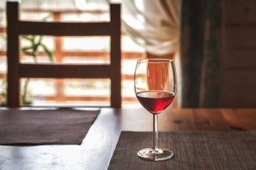 a glass of red wine on the table