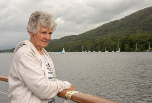 Senior Woman Overlooking Still Lake 