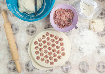 The process of cooking homemade dumplings. Homemade raw ravioli on a wooden Board. The dumpling making.