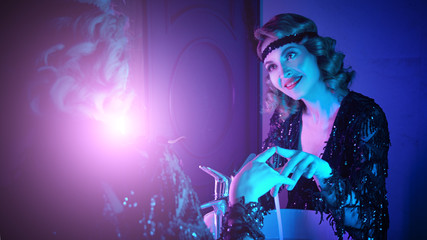 1920s retro style. Old times, Beautiful happy young girl dancing at a party in a nightclub in...