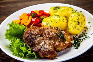 Grilled steak with boiled potatoes and vegetables