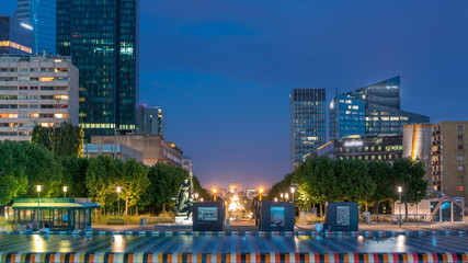 Paris cityscape with modern buildings in business district La Defense day to night timelapse. Glass...