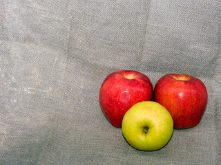  Three large juicy apples on a burlap background