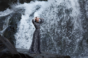 Girl on a background of a waterfall.
