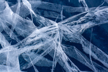 Long and deep cracks in the ice of Lake Baikal. Ice structure. Horizontal.
