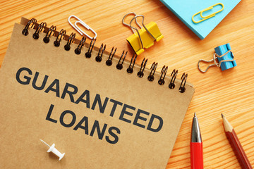 Conceptual photo showing printed text guaranteed loans
