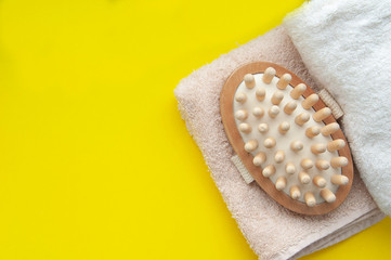 Ыpa treatments, towel and massage device on an tellow backround