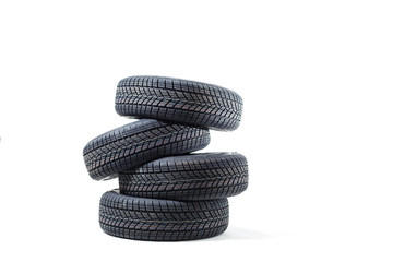 Fototapeta na wymiar four black tires isolated on white background