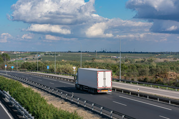 truck with refrigerated semi-trailer driving on the highway