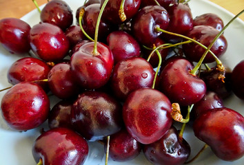 Ripe berries of sweet cherry. With water droplets on the berries. Selective focus. Vitamins from the garden.