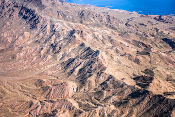 Fototapeta na wymiar Aerial Photography over western United States with landforms, mountains and Lake Mead in view