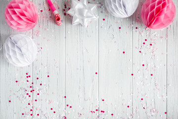 Background for congratulatory e-mail, pink banner on white wooden background. The basis for promotions, birthday. Party decorations. Flat lay, top view.