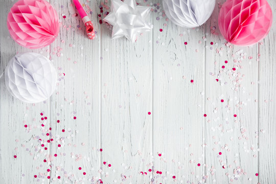 Background for congratulatory e-mail, pink banner on white wooden background. The basis for promotions, birthday. Party decorations. Flat lay, top view.