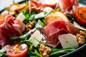 Tasty salad - ham and vegetables on wooden background
