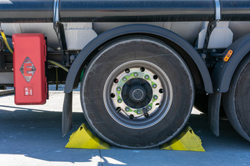 Tanker truck wheel with chocks placed for safety