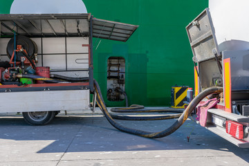 Hoses connected to a ship in the port for fuel supply