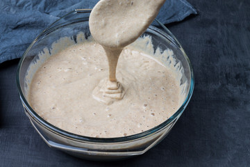 The process of checking the readiness of homemade sourdough for baking rye bread. Concept healthy eating