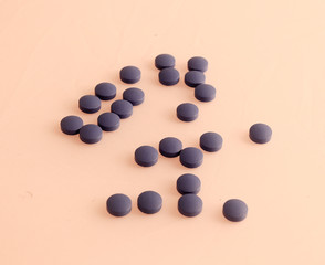 Purple pills on yellow background, Medical care and treatment