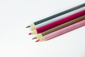 The set of colored pencil of different colors in raw on white background