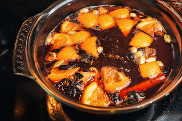 the process of making mulled wine at home in the kitchen. example of how a hot drink is prepared