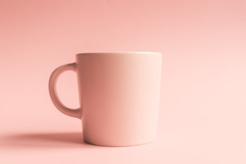 Pink cup on pink background. Mock up for your logo or text