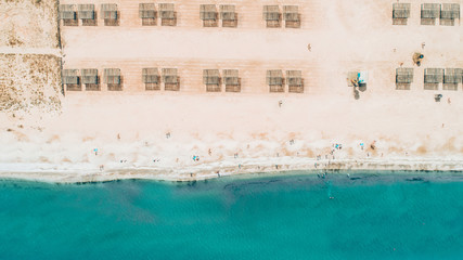 Seaside scenery drone view. Summer holiday destination. Sandy beach. Teal blue water.