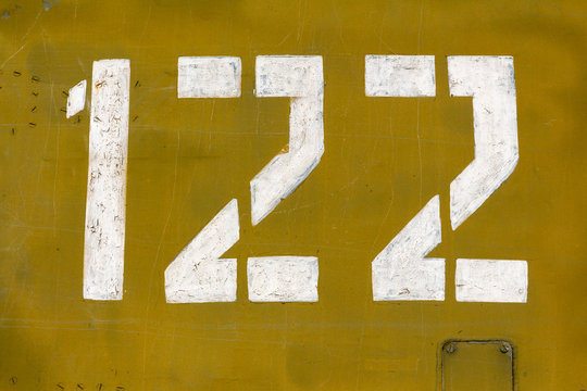 Number 122 on camouflage surface of military equipment