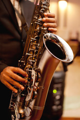 Fototapeta premium African American jazz musician playing the saxophone, closeup