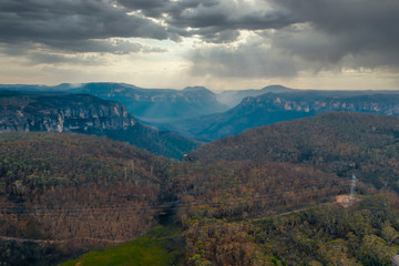 Fototapeta na wymiar A valley in sunshine and clouds in The Blue Mountains in Australia